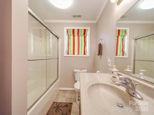 bathroom with baseboards, visible vents, shower / bath combination with glass door, crown molding, and toilet