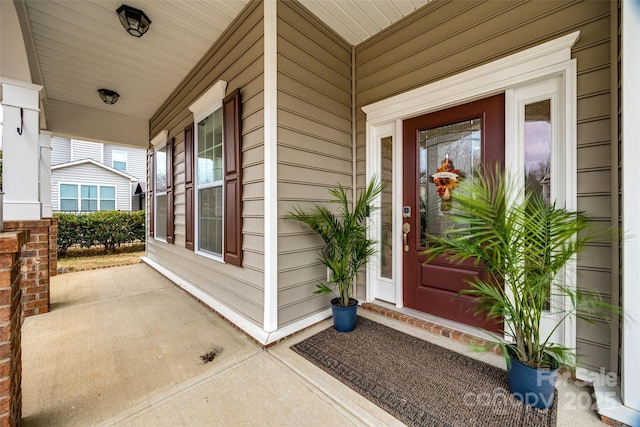 view of exterior entry with covered porch