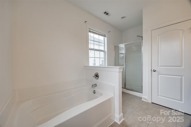 full bathroom featuring tile patterned floors, visible vents, a shower stall, and a garden tub