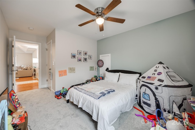 carpeted bedroom featuring baseboards and a ceiling fan