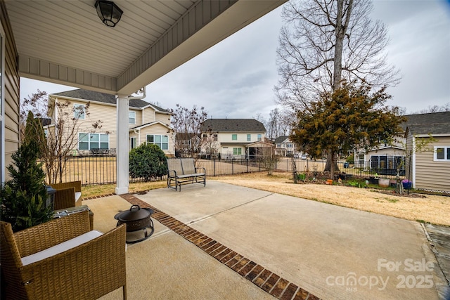 view of patio / terrace with fence and a residential view