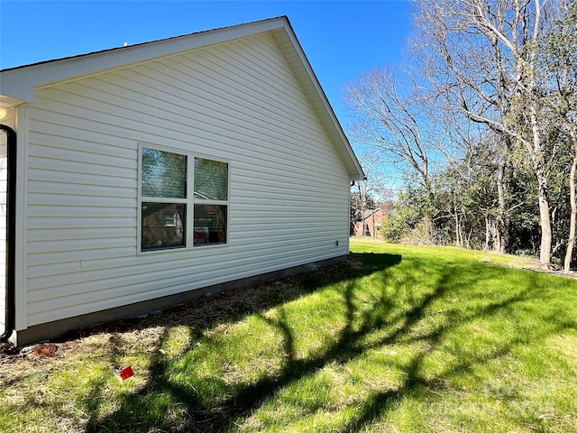 view of side of home with a lawn