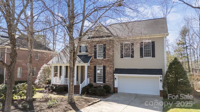 view of front of property with an attached garage, driveway, and roof with shingles