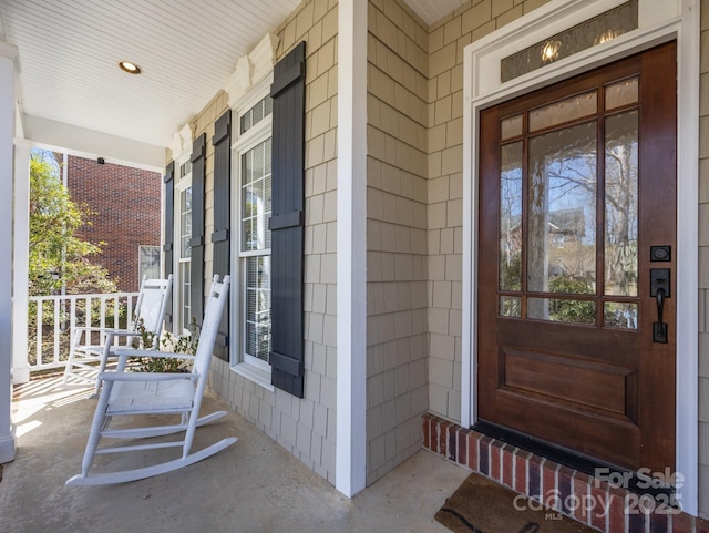 view of exterior entry featuring a porch