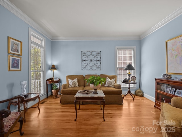 living room featuring baseboards, crown molding, and light wood-style floors