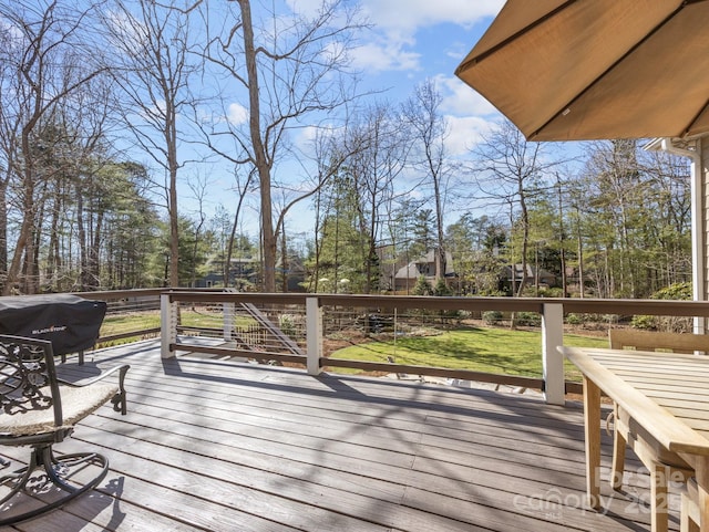 wooden deck featuring a lawn