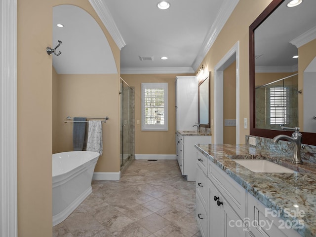 full bath with crown molding, a stall shower, visible vents, and a sink