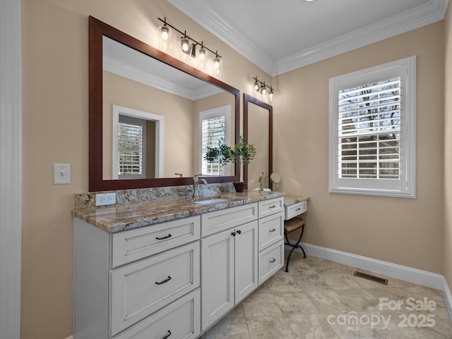 bathroom with vanity, crown molding, visible vents, and baseboards