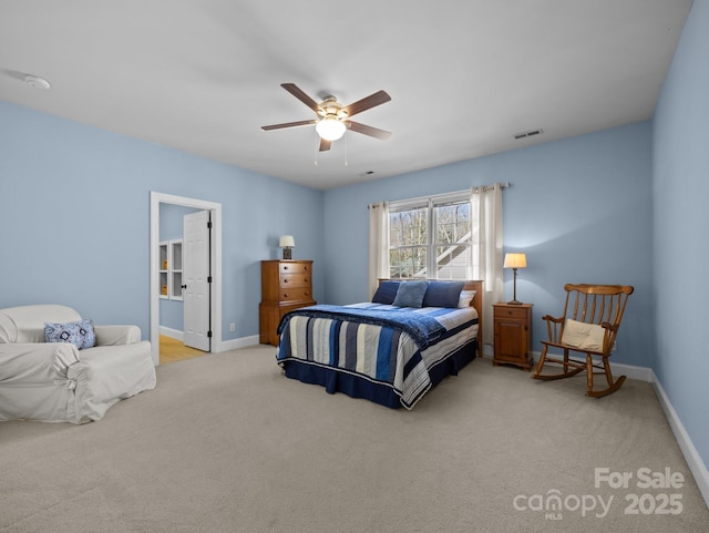 bedroom featuring ceiling fan, baseboards, visible vents, and light carpet