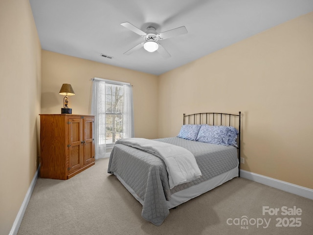 bedroom featuring light carpet, visible vents, and baseboards