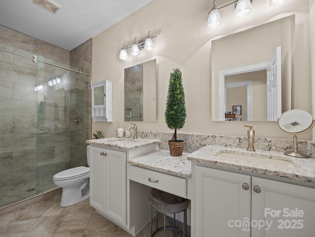 full bathroom featuring visible vents, a stall shower, and vanity