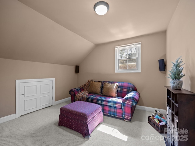 living area with baseboards, lofted ceiling, and carpet flooring