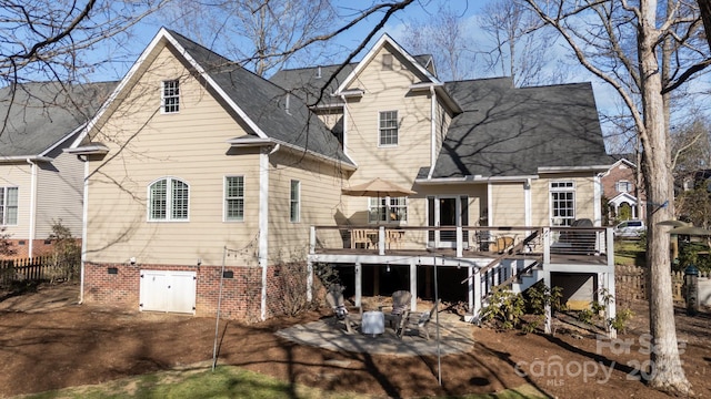 rear view of property featuring fence, a wooden deck, stairs, crawl space, and a patio