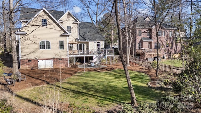 rear view of house featuring fence, stairs, a yard, a deck, and a patio