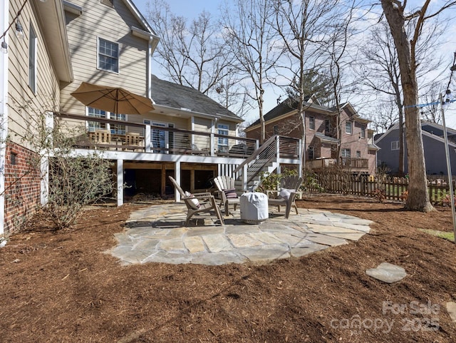 exterior space with stairs, a deck, and fence