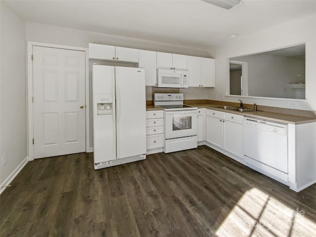 kitchen featuring white appliances, dark wood-style flooring, a sink, baseboards, and white cabinets