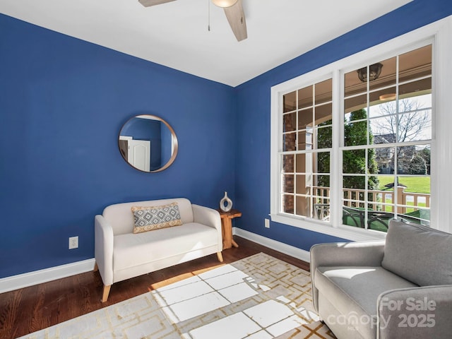 sitting room featuring ceiling fan, baseboards, and wood finished floors