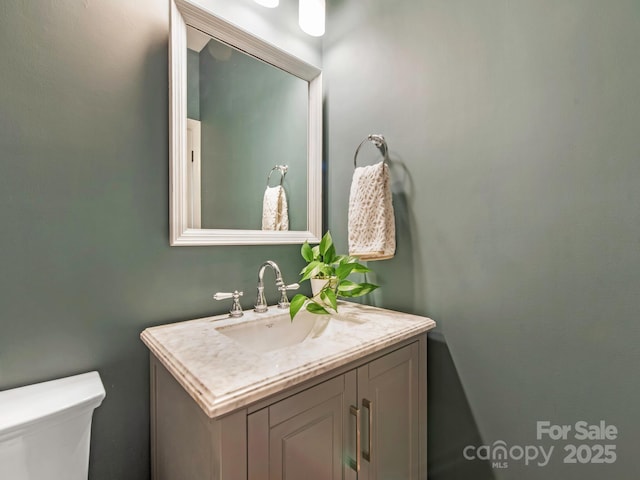 bathroom featuring toilet and vanity