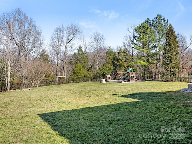 view of yard featuring a playground and fence