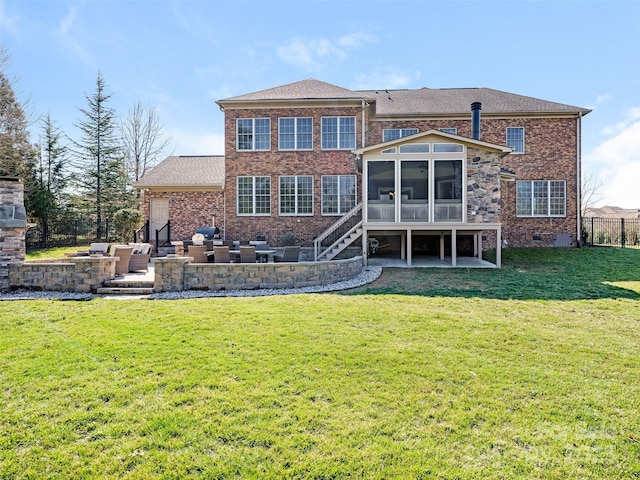 rear view of house featuring an outdoor living space, a sunroom, crawl space, a patio area, and brick siding