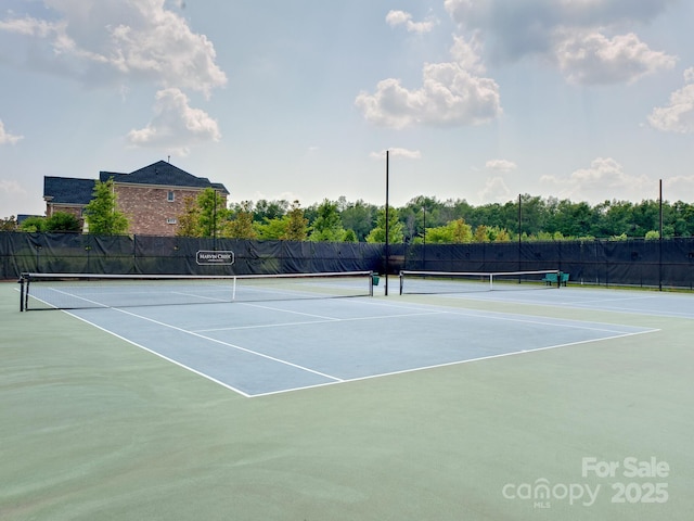 view of tennis court featuring fence