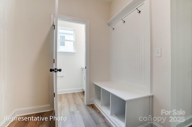 mudroom with light wood finished floors and baseboards