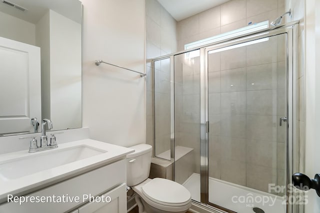 full bathroom featuring visible vents, a shower stall, toilet, and vanity