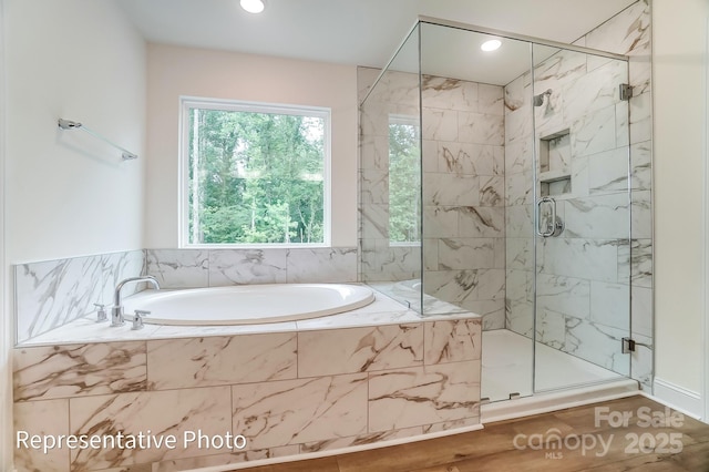 full bathroom with a bath, recessed lighting, and a shower stall