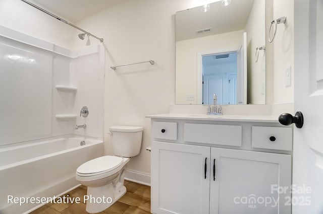 bathroom featuring vanity, wood finished floors, visible vents, bathing tub / shower combination, and toilet