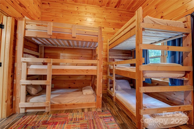 unfurnished bedroom featuring a sauna, wood finished floors, and wood walls