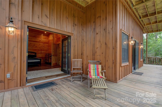 wooden terrace featuring visible vents