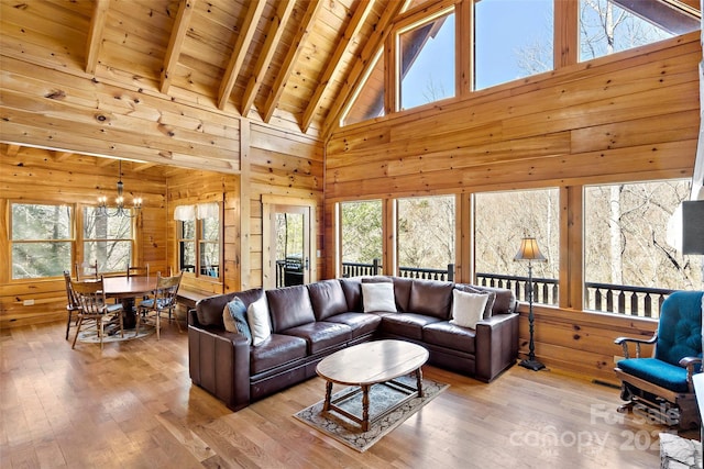 200 Blue Gill Dr, Lake Lure, NC 28746 - living area featuring a notable chandelier, plenty of natural light, wood finished floors, wooden walls, and wooden ceiling