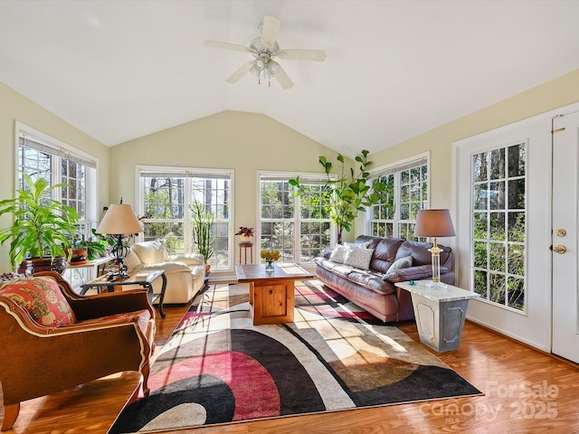 sunroom featuring a healthy amount of sunlight, french doors, a ceiling fan, and vaulted ceiling