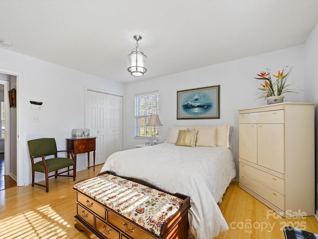 bedroom featuring a closet and light wood-style floors