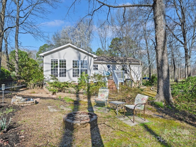 view of front of property with a wooden deck and an outdoor fire pit