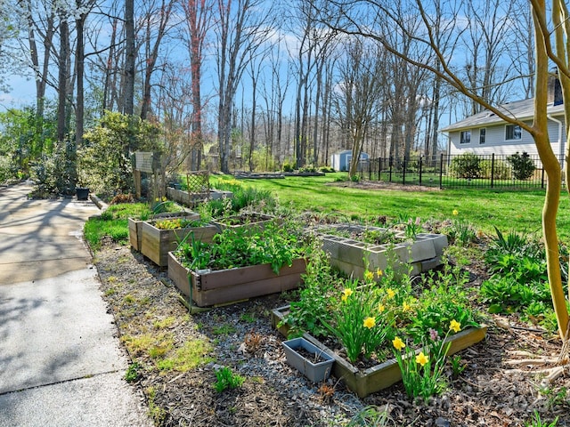 view of yard featuring a vegetable garden and fence