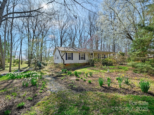 ranch-style home with crawl space and dirt driveway