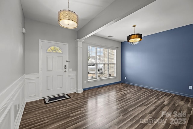 11712 Huxley Rd, Charlotte, NC 28277 - foyer featuring a decorative wall, dark wood-style floors, visible vents, and wainscoting
