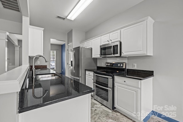 11712 Huxley Rd, Charlotte, NC 28277 - kitchen with visible vents, white cabinets, stainless steel appliances, and a sink