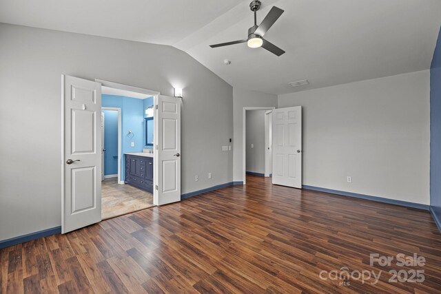 11712 Huxley Rd, Charlotte, NC 28277 - unfurnished bedroom featuring visible vents, baseboards, dark wood finished floors, lofted ceiling, and ensuite bath