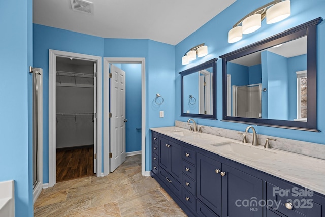 11712 Huxley Rd, Charlotte, NC 28277 - full bathroom featuring a shower stall, a spacious closet, visible vents, and a sink