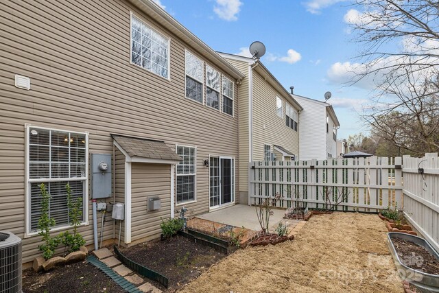 11712 Huxley Rd, Charlotte, NC 28277 - back of house featuring a patio, central air condition unit, fence, and a garden