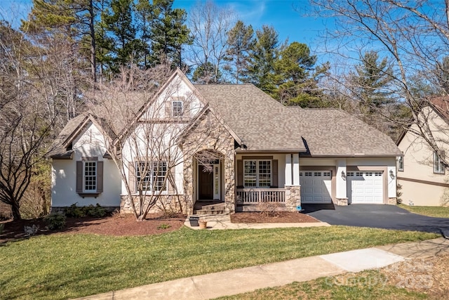 tudor home with an attached garage, roof with shingles, stucco siding, stone siding, and driveway