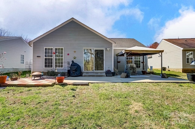 back of property featuring a patio and a yard