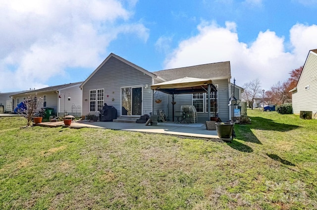 back of property featuring a yard, entry steps, a gazebo, and a patio