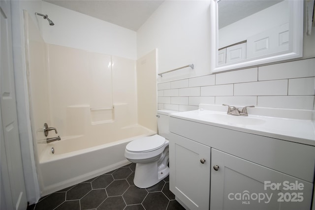 bathroom with tile walls, shower / bath combination, toilet, vanity, and tile patterned flooring