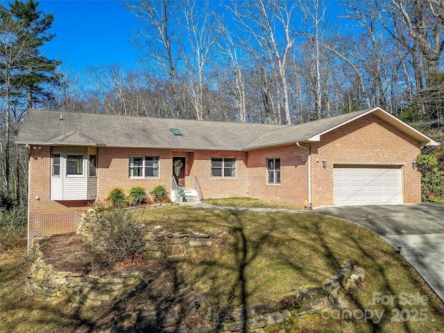 ranch-style home with brick siding, a shingled roof, a front lawn, concrete driveway, and an attached garage