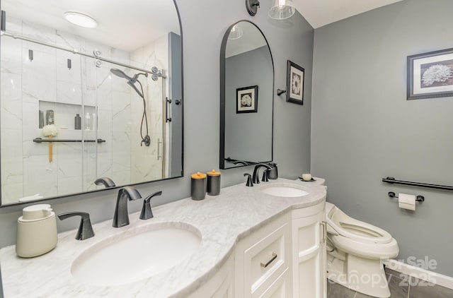 full bath featuring toilet, a shower stall, double vanity, and a sink