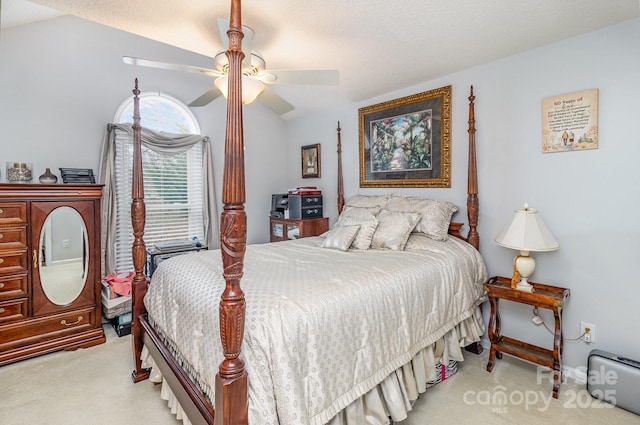 bedroom featuring a ceiling fan, lofted ceiling, and light carpet