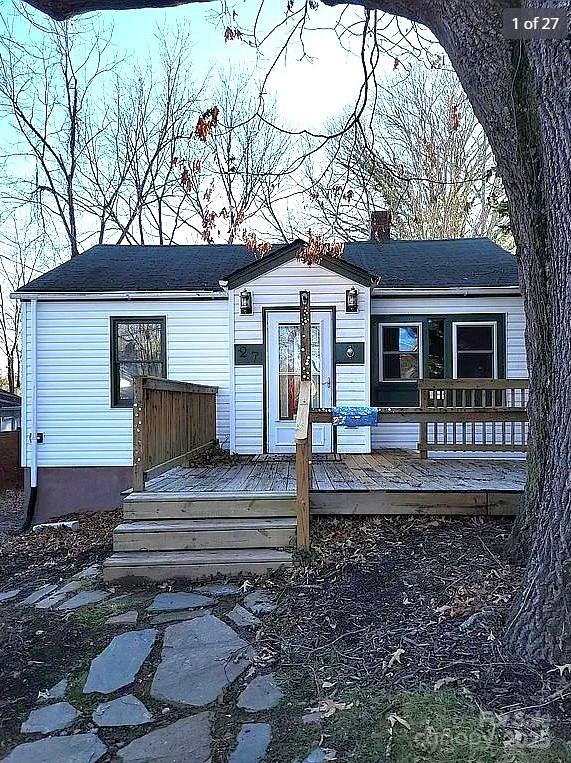 view of front of home featuring a chimney and a deck